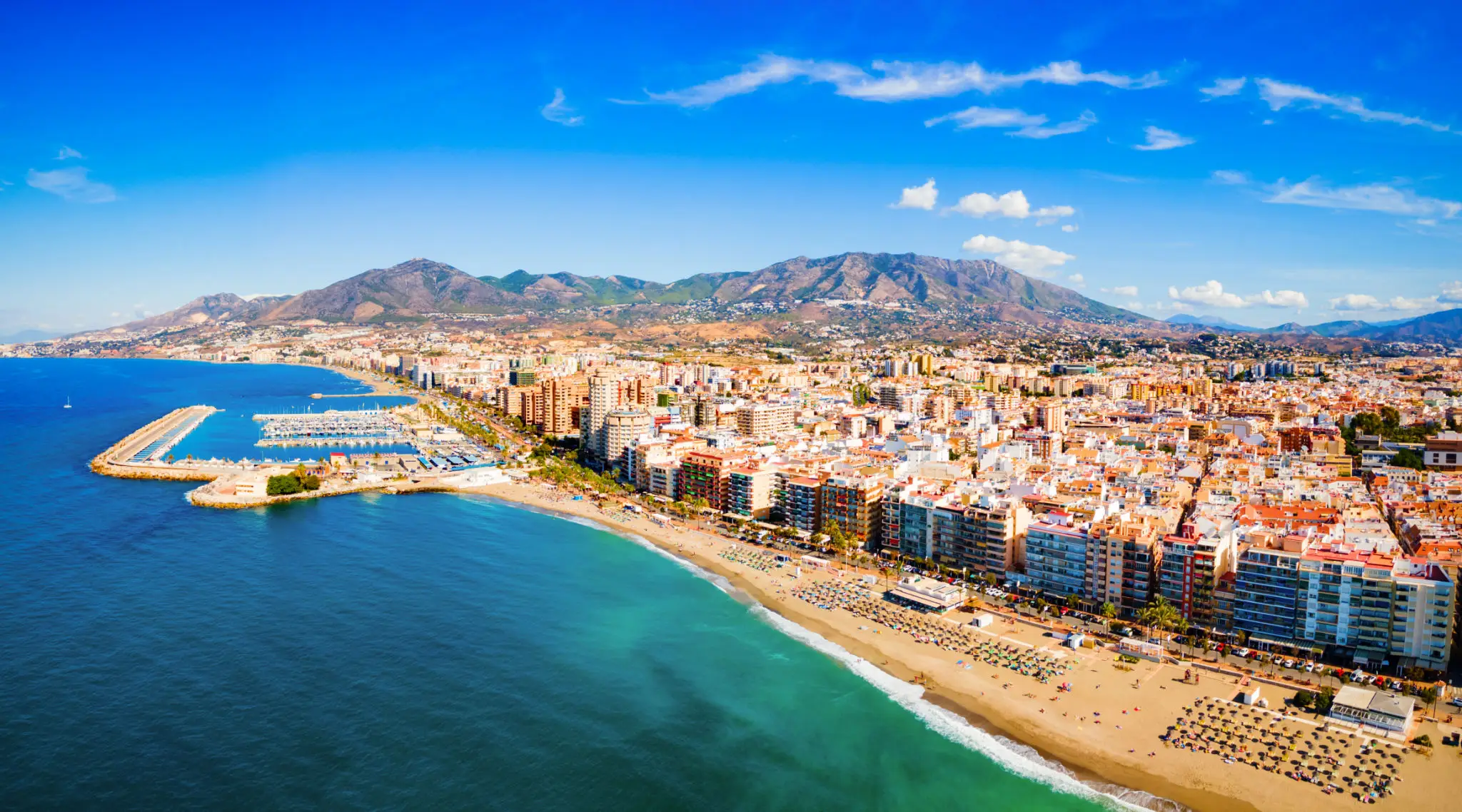 Aerial view of Mediterranean beachfront city and marina