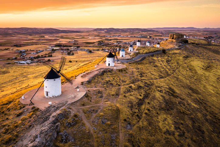 Row of traditional white windmills on hillside