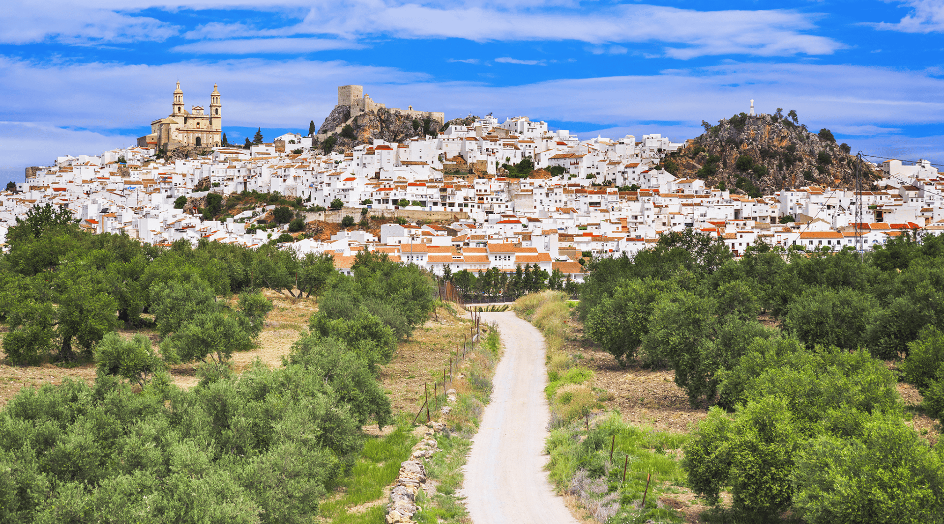 Winding road to white hilltop town with castle