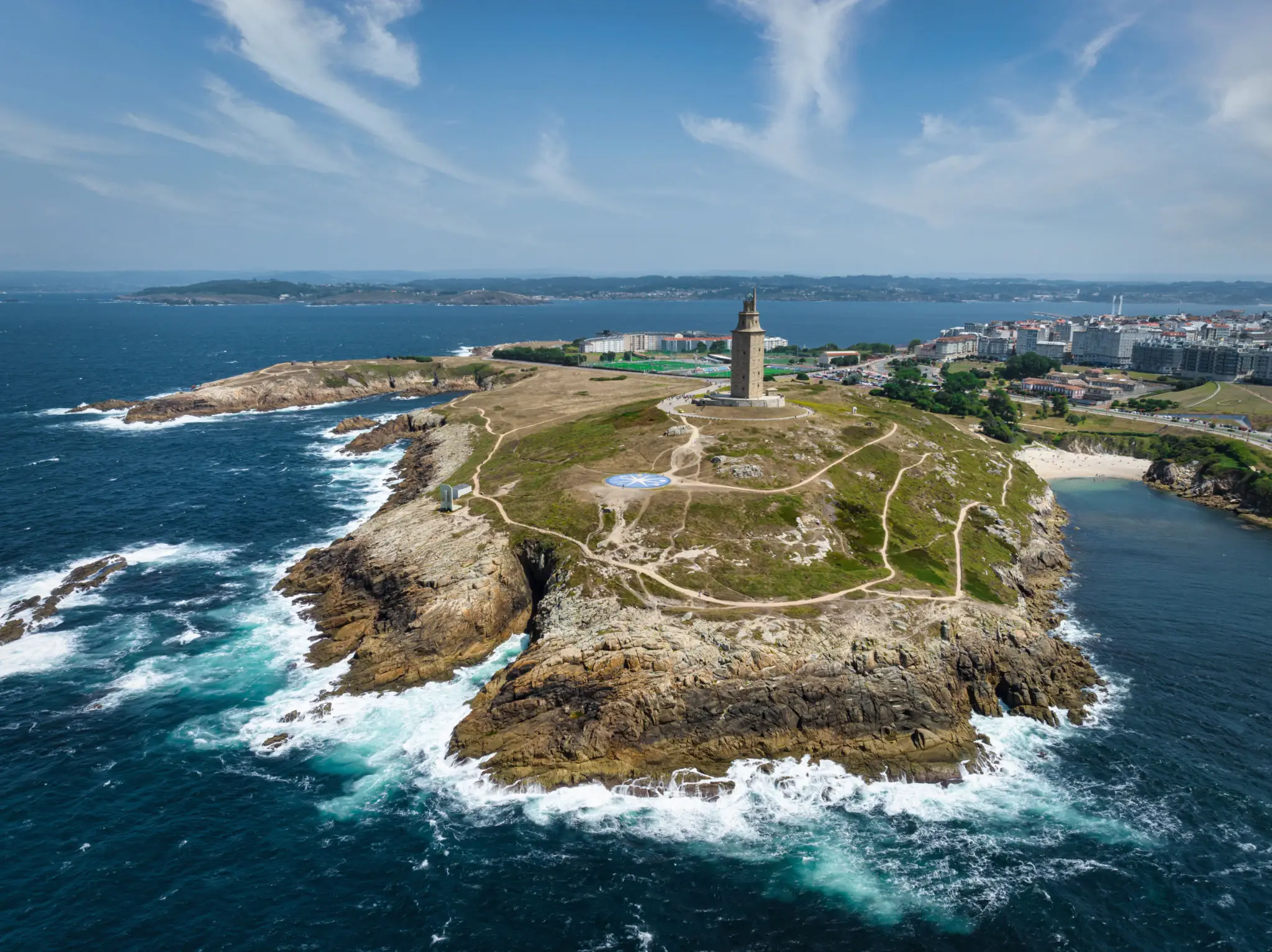Aerial view of lighthouse on rocky coastal headland