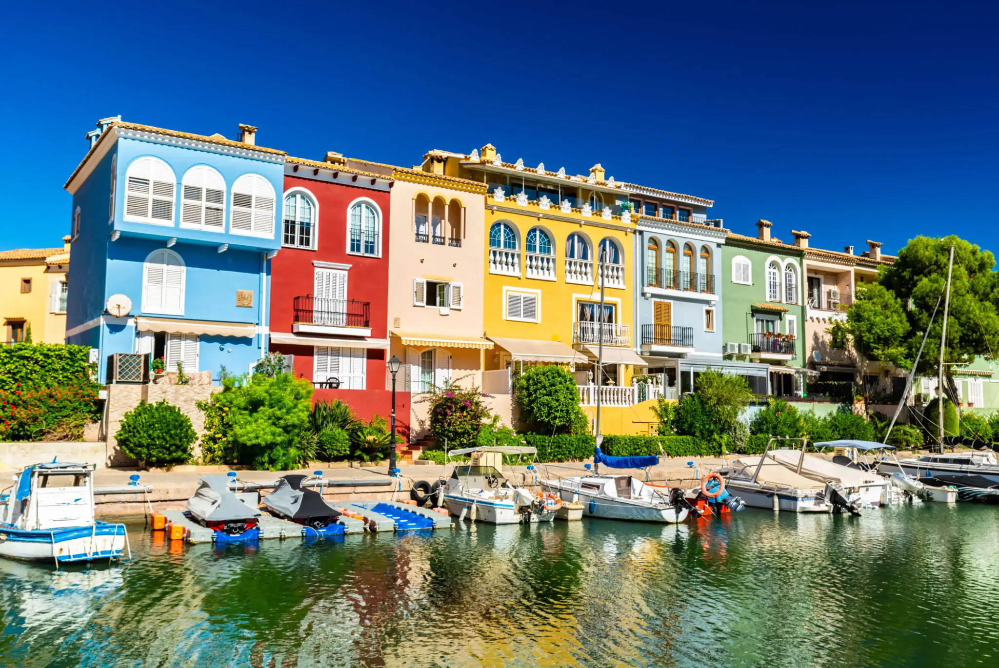 Colorful waterfront houses with docked small boats