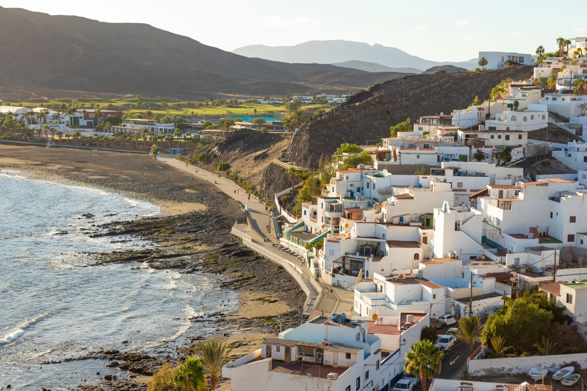 White Mediterranean hillside village overlooking rocky coast