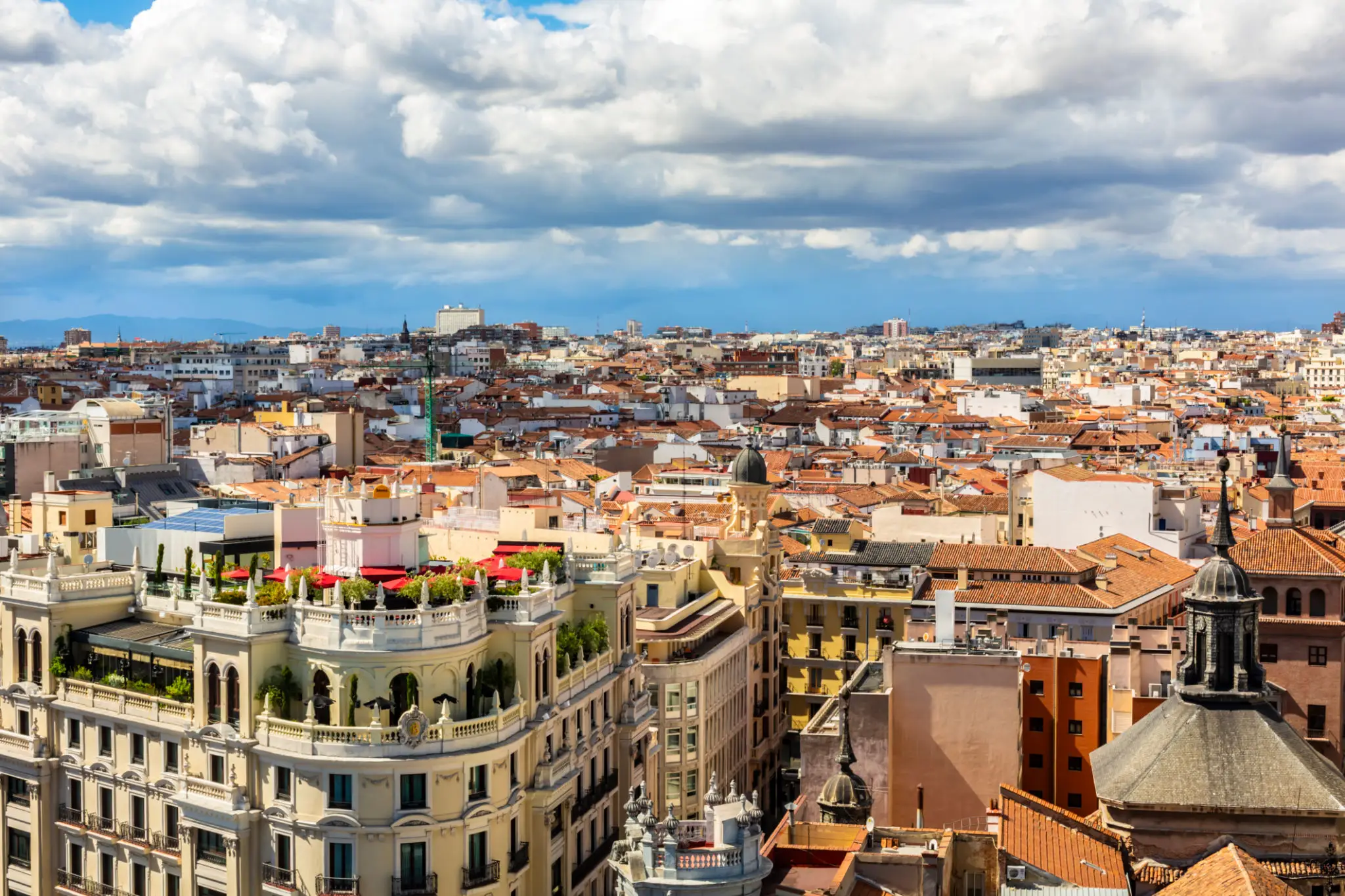 European city rooftops under cloudy sky