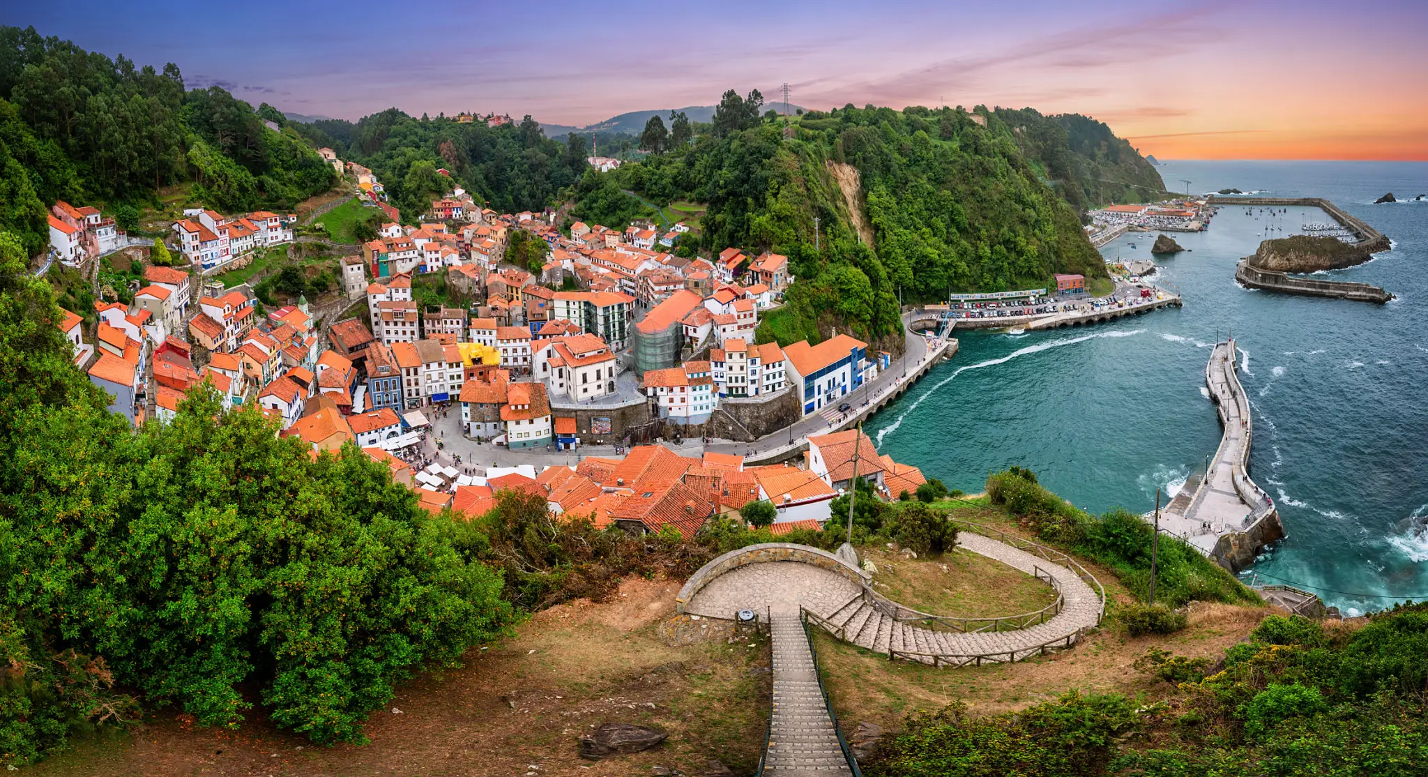 Picturesque coastal village with harbor and winding path