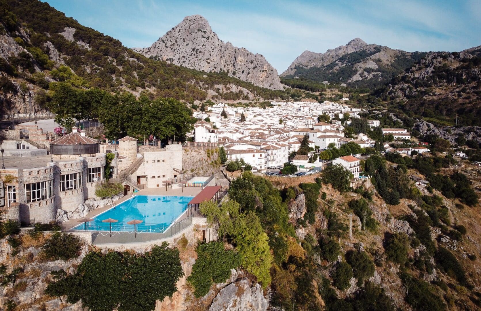 Aerial view of mountain village with cliffside pool