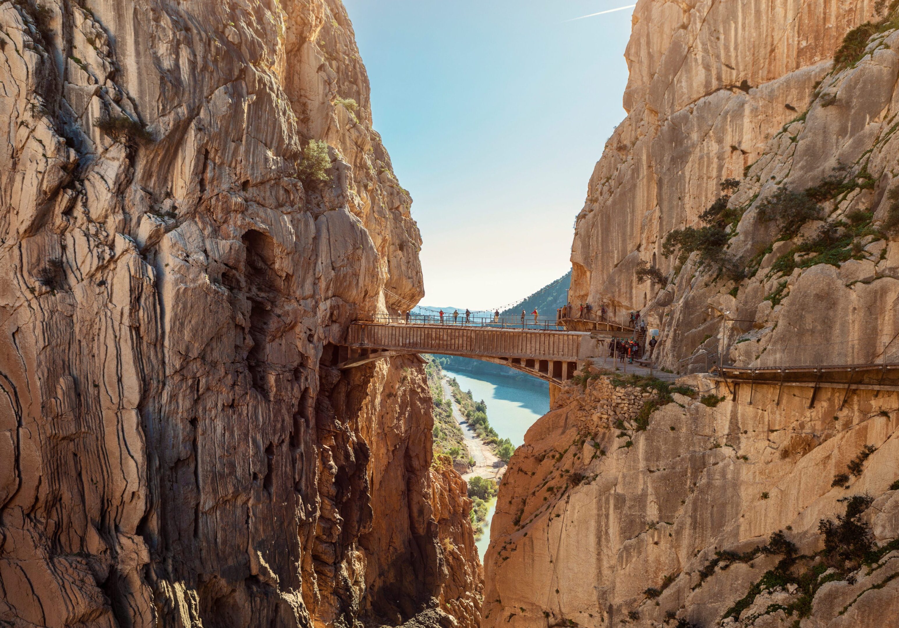 Cliffside walkway bridge over canyon with river