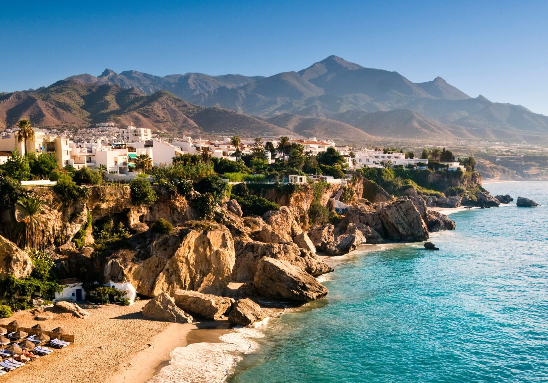 Mediterranean town on cliffs above turquoise sea