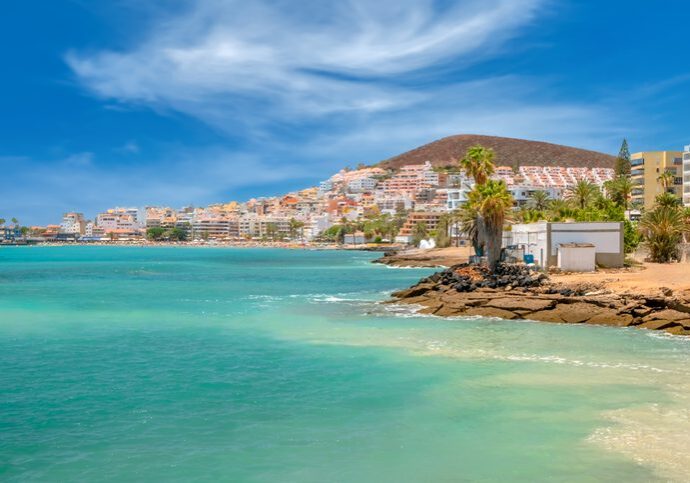 Coastal town with turquoise water and palms